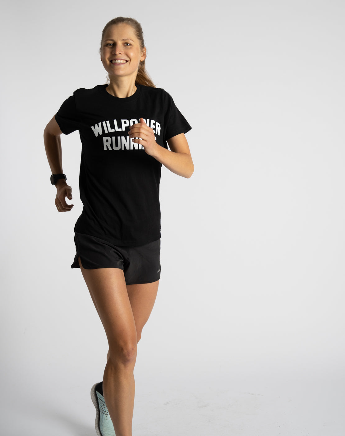 Person running wearing a black t-shirt with 'WILDPACK RUN' text on a white background