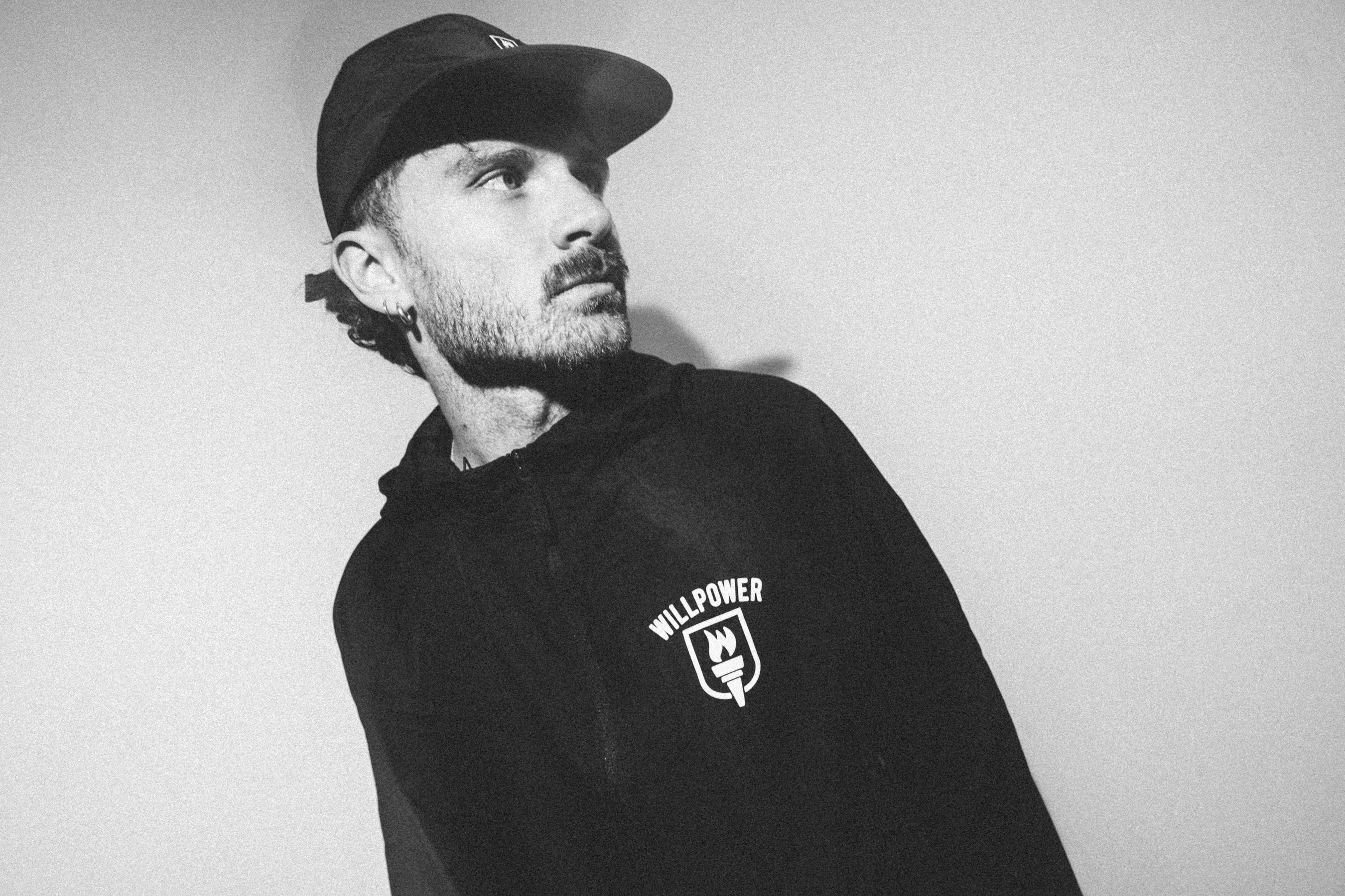 Man wearing a black hoodie with 'WILDPower' logo against a plain background